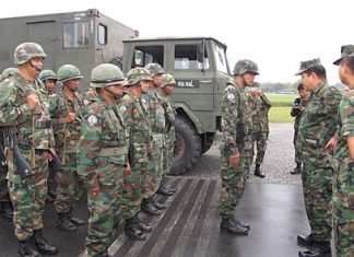Senior Capt. Suthinan Samarak, Commander of Air Force Command 2, inspects his troops before military exercises begin.